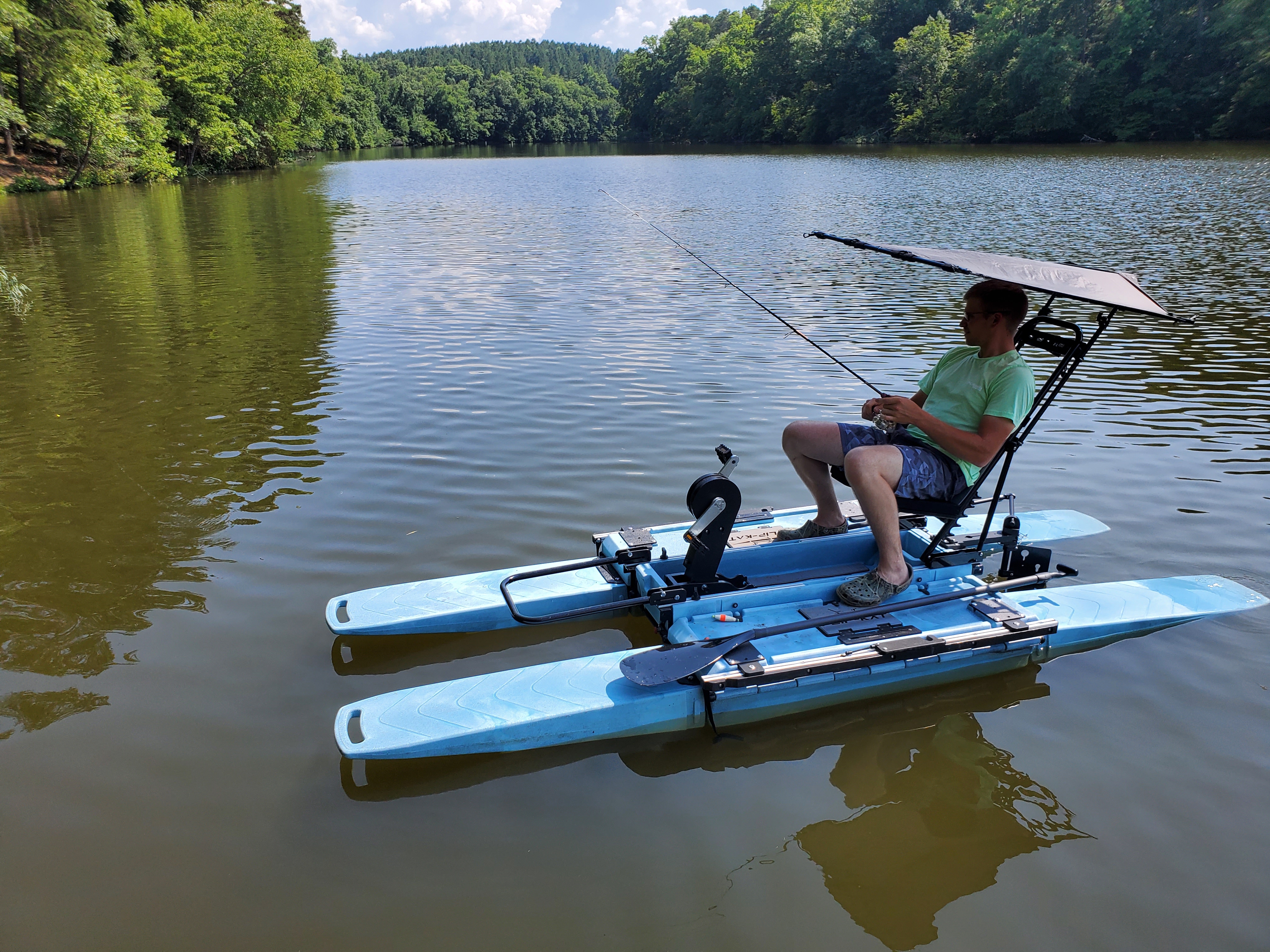Fisherman Under Canopy on Portable Kayak