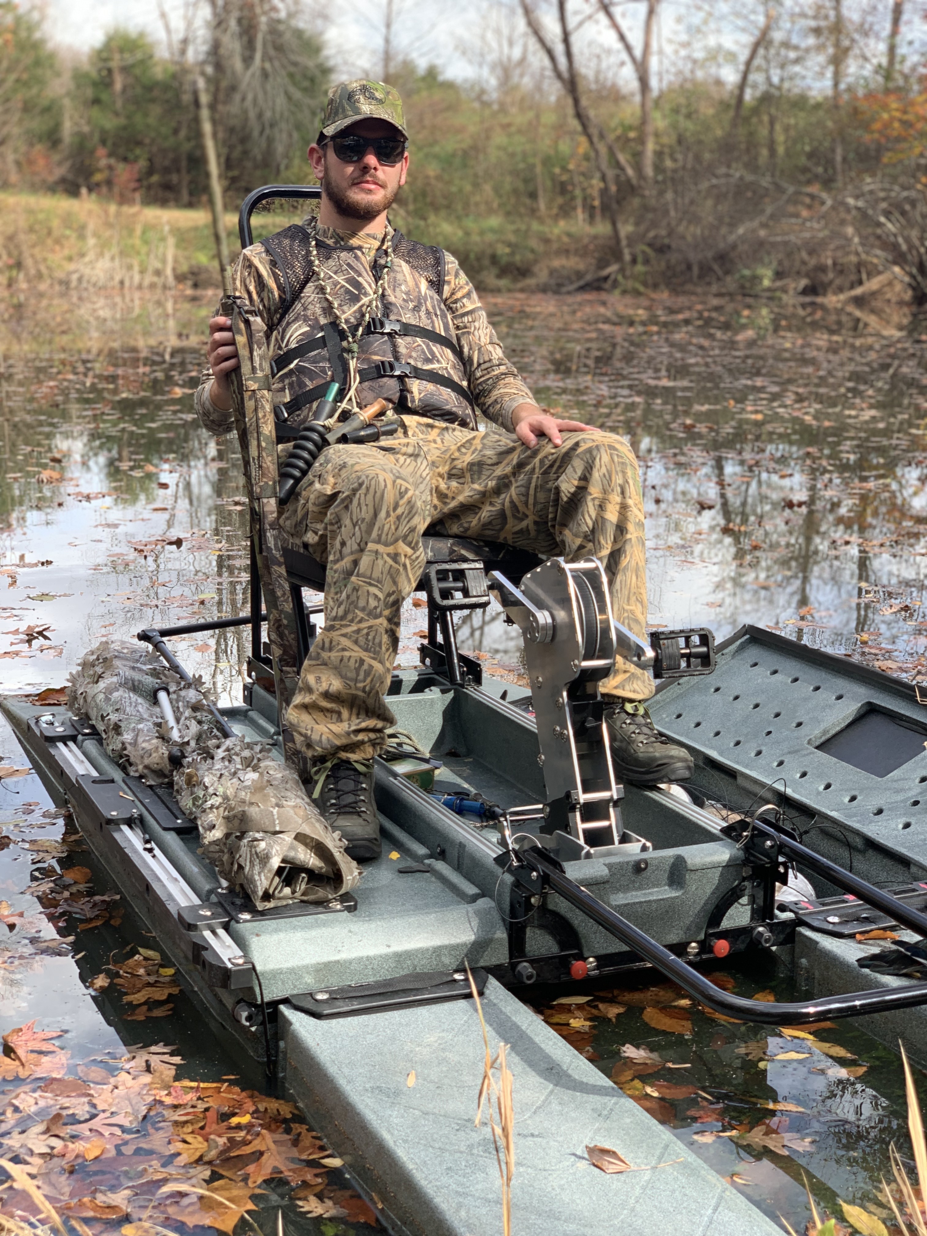 hunter in camo on portable kayak